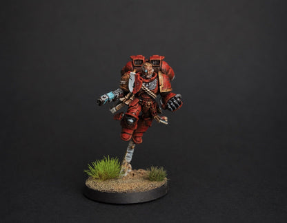 Hand-painted Space Marine Captain with jump pack miniature in red armor, dynamic flight pose with freehand chapter iconography, display commission by Alto Studio