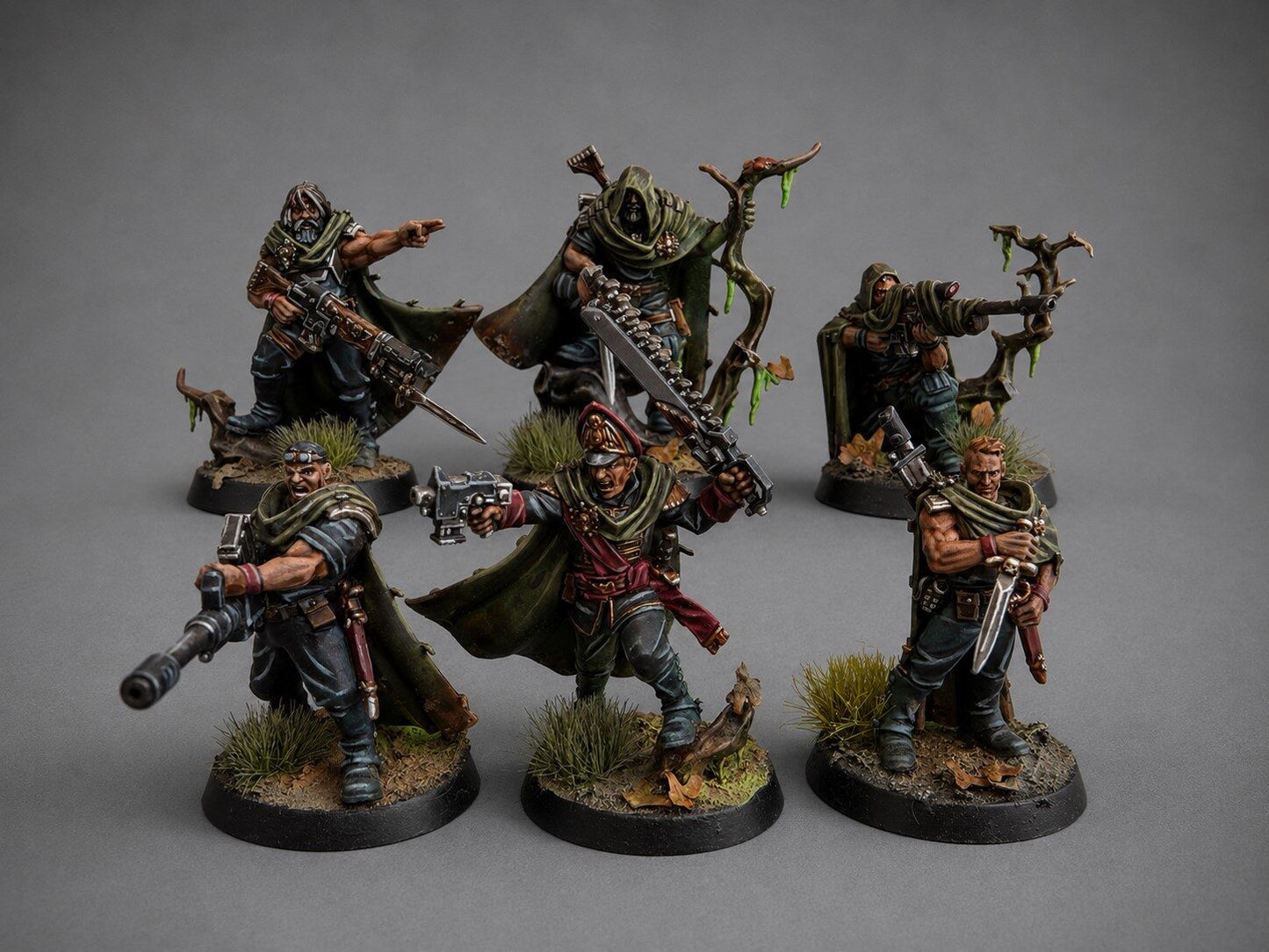 Hand-painted Gaunt's Ghosts Tanith squad miniatures in weathered camo greatcoats on a themed forest base, narrative commission by Alto Studio