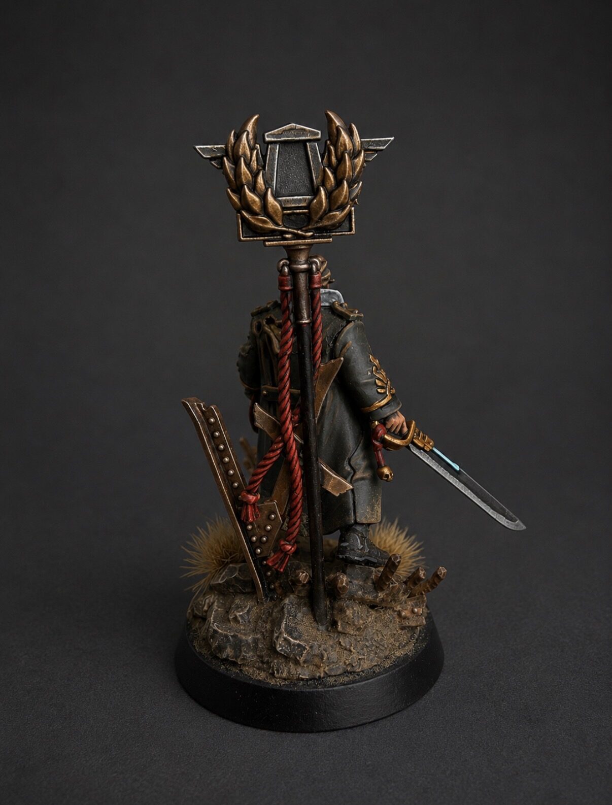 Hand-painted Ursula Creed Cadian command officer miniature, back view showing regimental standard and NMM metallic details, display commission by Alto Studio