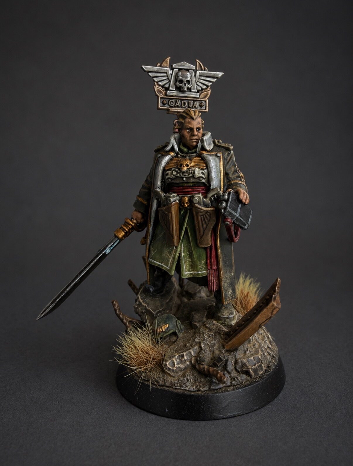 Hand-painted Ursula Creed Cadian command officer miniature, front view with ornate armor, sword, and Cadian regimental badge, display commission by Alto Studio